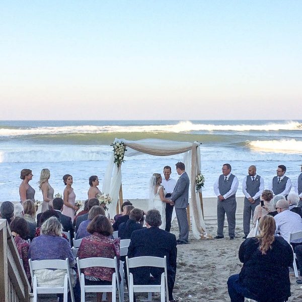 This couple gets married at a beach wedding on the outer banks at the sea ranch resort, this couple is at the wedding venue on the outer banks located at the sea ranch resort, the sea ranch resorts celebrates weddings on the obx