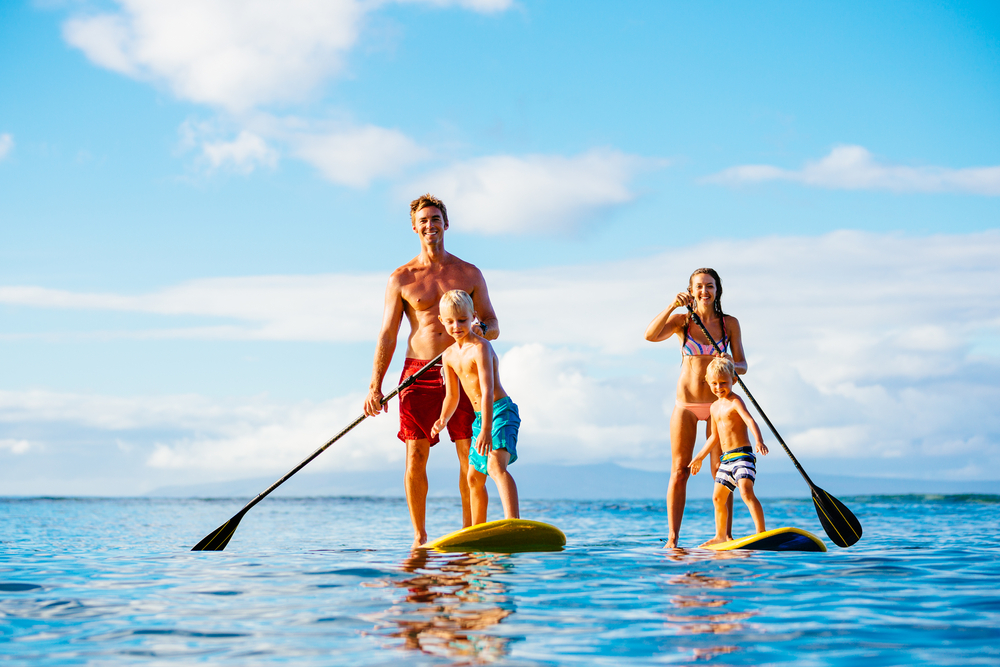 Stand up paddle boarding family that is staying at the Sea Ranch Resort