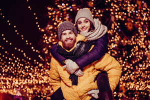 Photo of a couple under Christmas Lights in NC