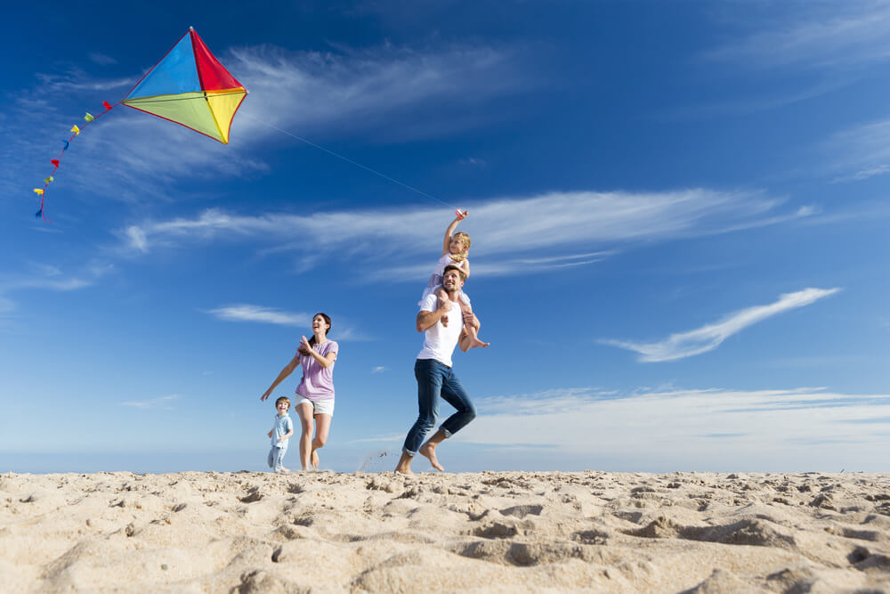 A photo of a family flying a kite, one of the many things to do in Kill Devil Hills NC