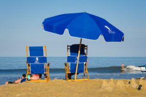 People relaxing on the beach after hiking trails near Pine Island Audubon Sanctuary.