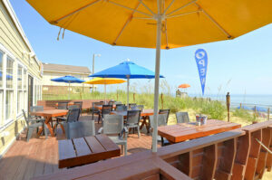 The outdoor dining space of a Kill Devil Hills resort to dine at after getting sweet treats from an Outer Banks bakery.