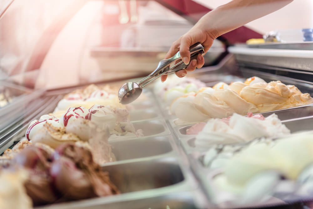 A person scooping ice cream at a Kill Devil Hills shop.