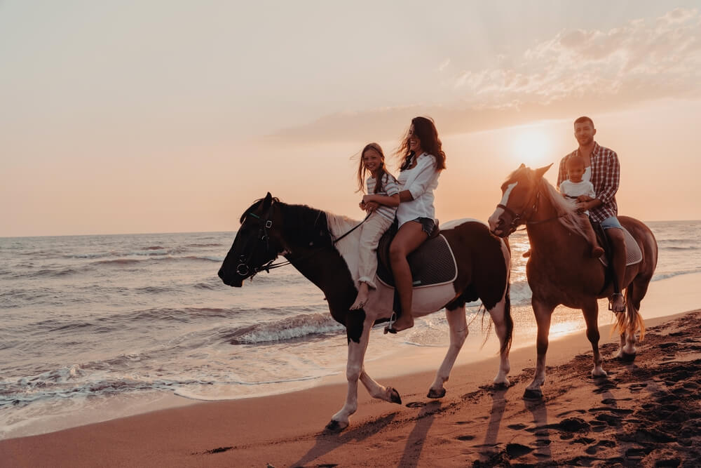 A family horseback riding in the Outer Banks on their North Carolina vacation.