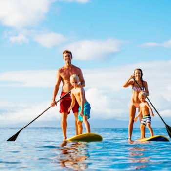 Stand up paddle boarding family that is staying at the Sea Ranch Resort