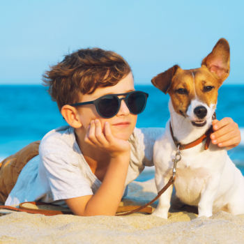 Photo of a Child with His Pup During a Outer Banks Dog-Friendly Vacay